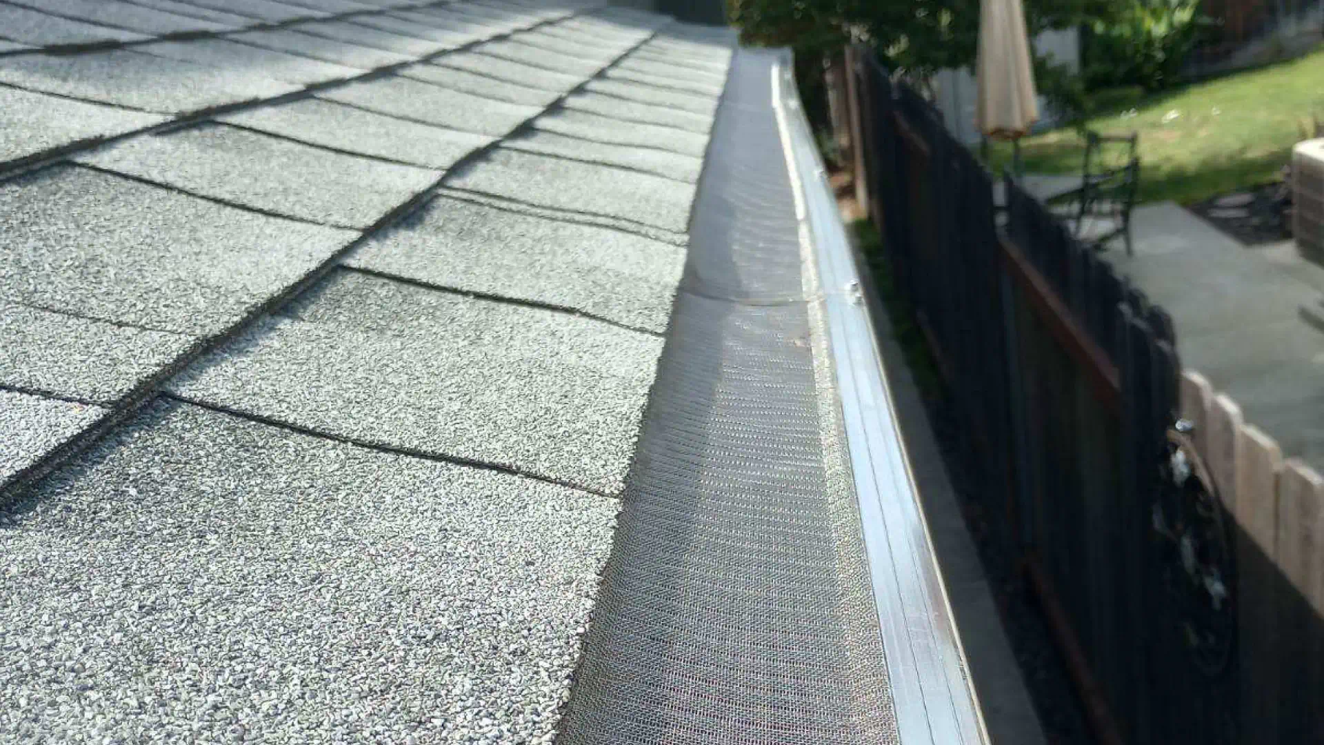 closeup shot of newly installed roof gutter with screen modesto ca